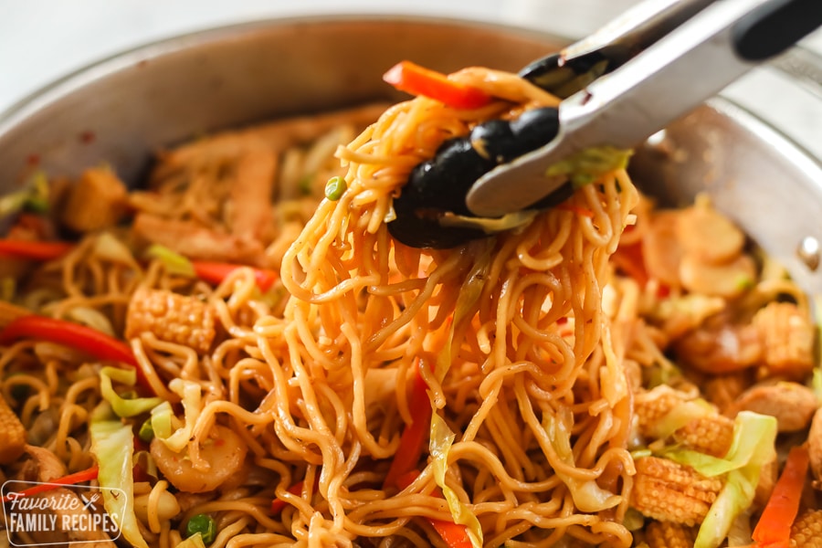 Yakisoba noodles in a skillet being served.