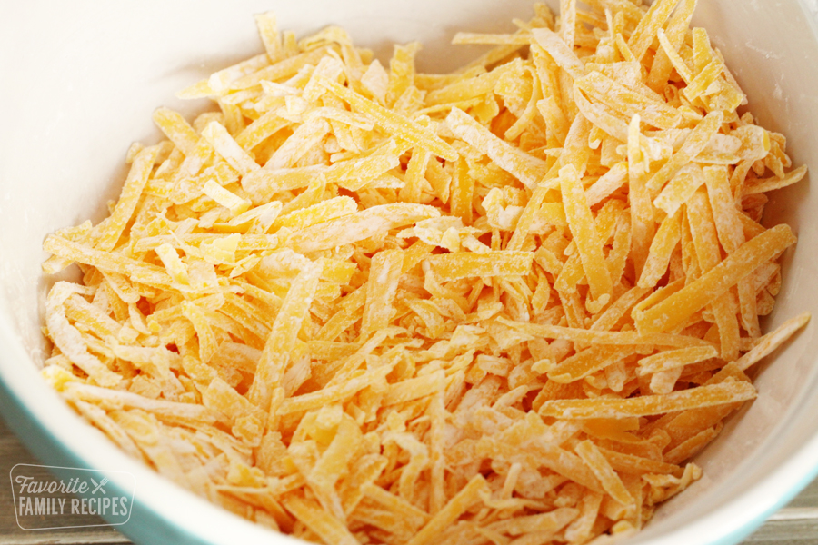 Bowl of shredded cheddar cheese dusted with cornstarch