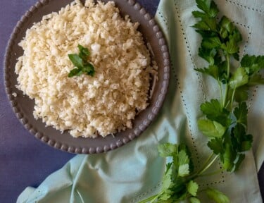 Cauliflower rice on a gray bowl.