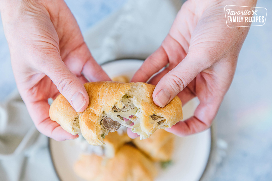 Cheese pull of a cheesesteak crescent roll