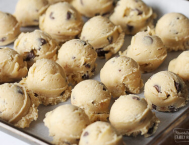 Cookie dough scoops on a baking sheet