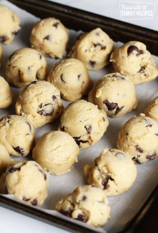 Cookie dough scoops on a tray for freezing