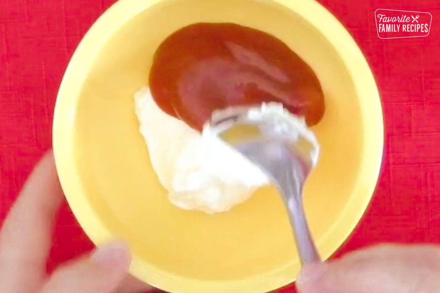Mixing together ketchup and mayo fro fry sauce