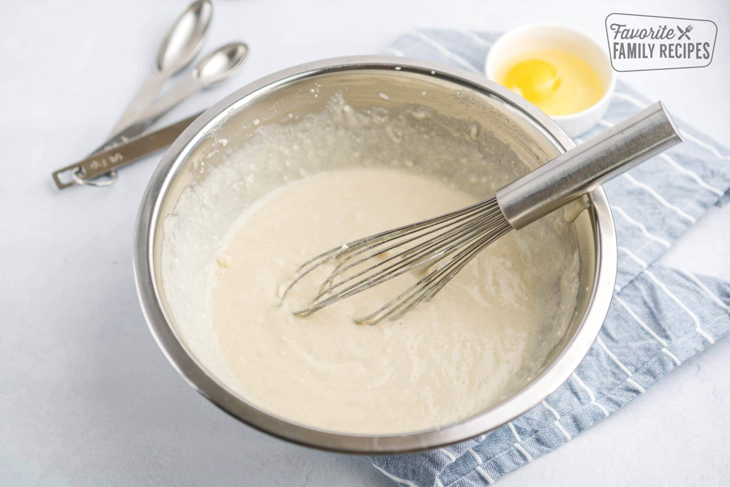 Homemade cake mix and sunny yellow cake in a mixing bowl.