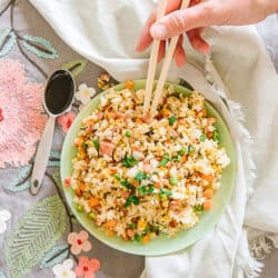 Ham Fried Rice in a bowl with soy sauce in a teaspoon on the side