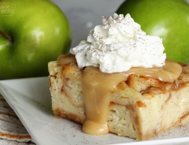 Slice of bread pudding with caramel sauce and whipped cream