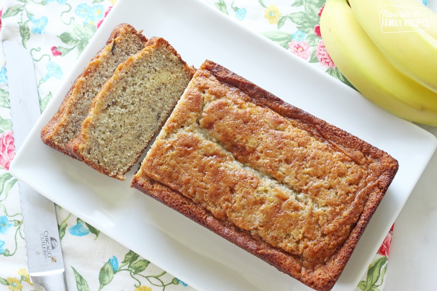 A loaf of banana bread with two slices cut off of one end.