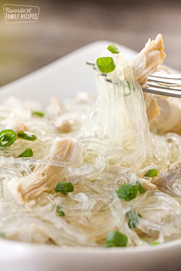 Closeup of glass noodles in a bowl with a fork