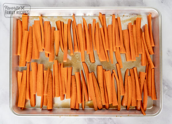 Julienned carrots lined up on a baking sheet