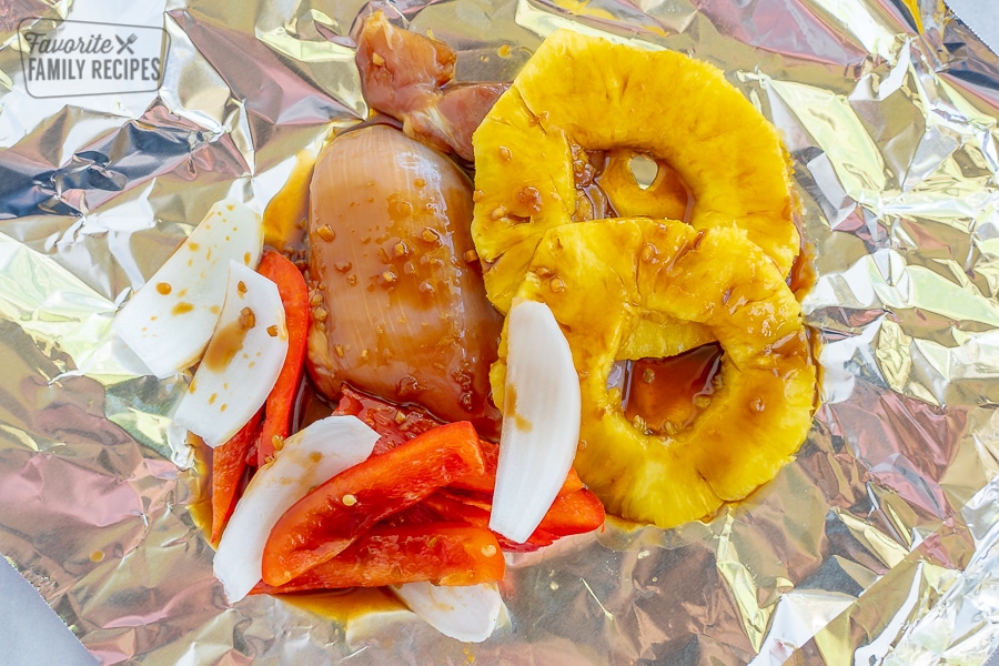 Hawaiian chicken in a foil packet with pineapple, peppers, and onions