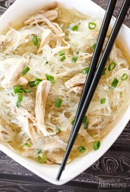 Glass noodles in a bowl with shredded chicken and green onions