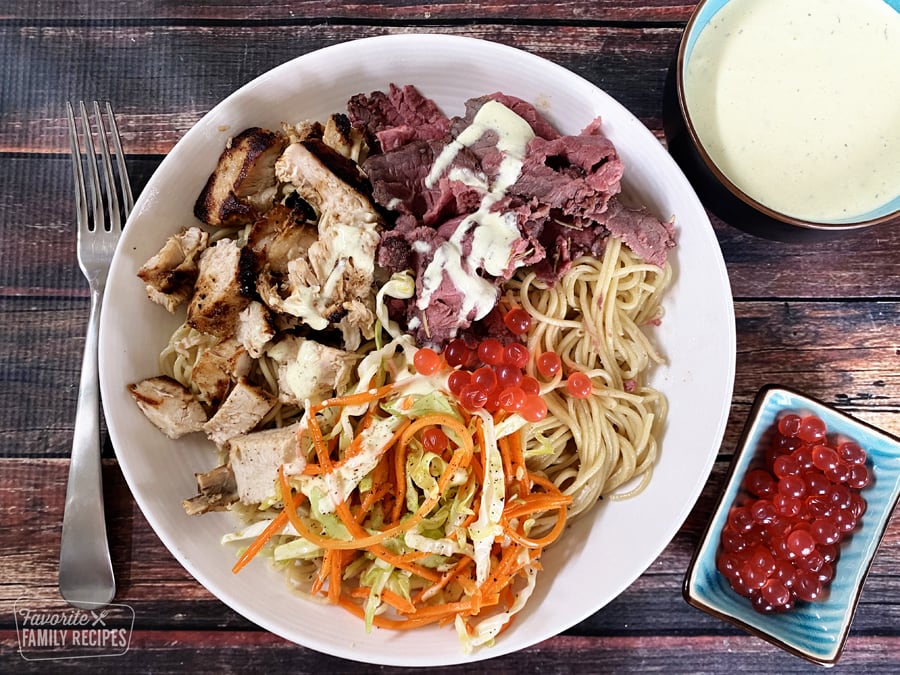 Satu’li Bowl with noodles, chicken, beef, and slaw in a bowl