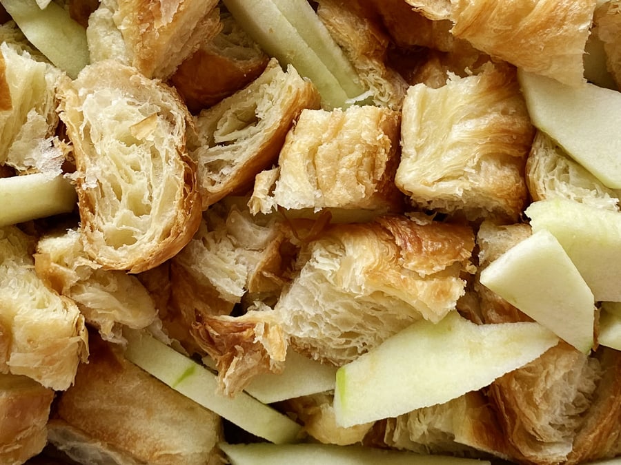 Cut up croissants and apples 
