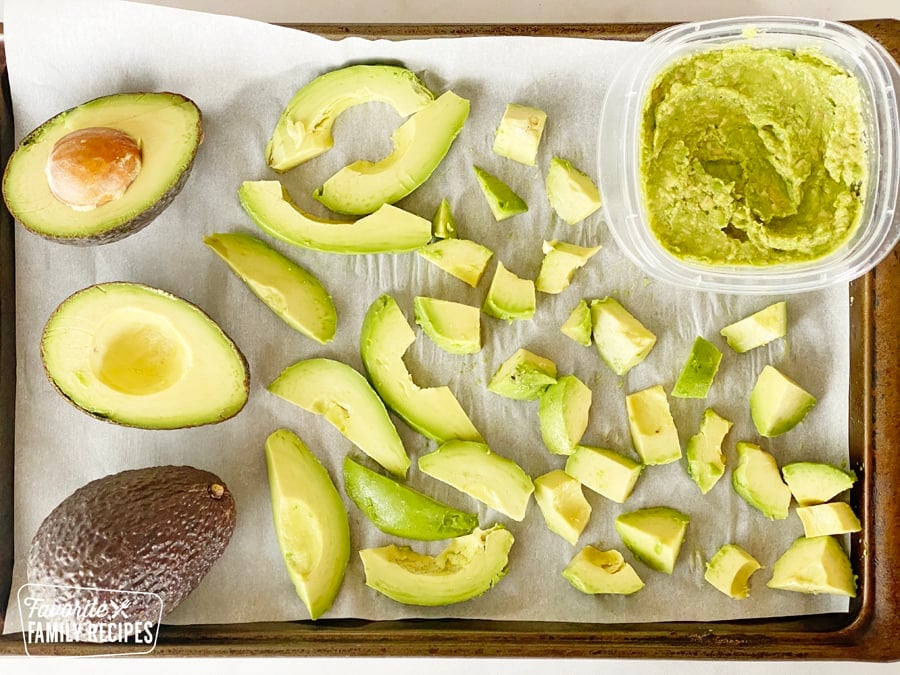 Different sized avocado slices on a tray