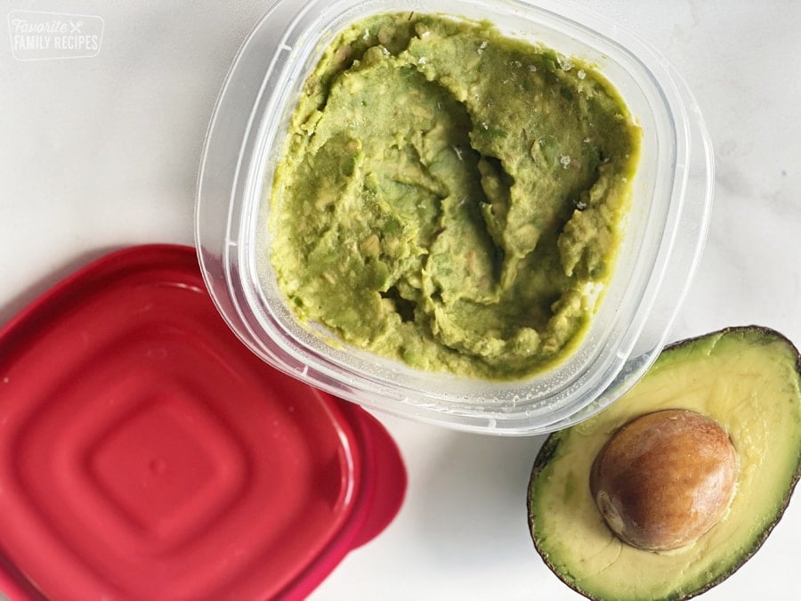 Mashed avocado in a container to be frozen