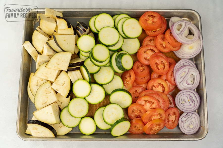 Sliced eggplant, zucchini, tomatoes, and red onion.