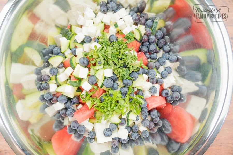 Mint and basil leaves on top of watermelon feta salad