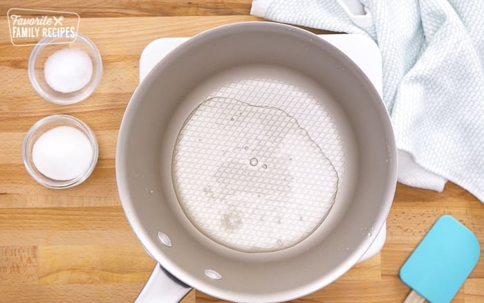 Rice vinegar in a pot to make sushi rice for sushi rolls