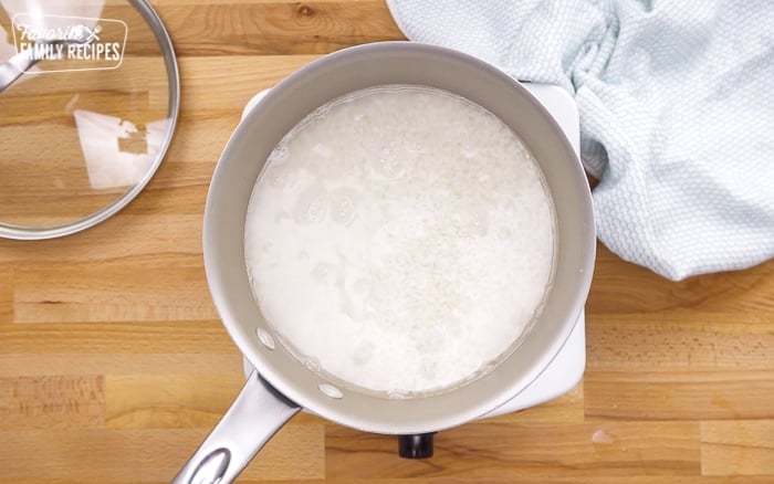 Rice simmering in a pot to make sushi rice