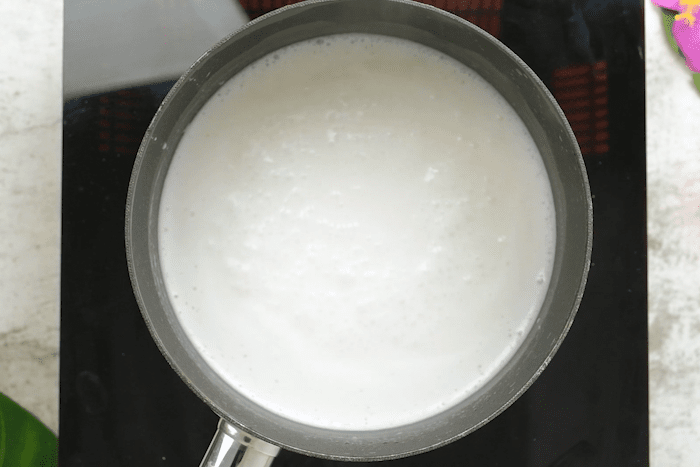 Coconut milk and sugar in a pot for Authentic Hawaiian Haupia (Coconut Pudding).