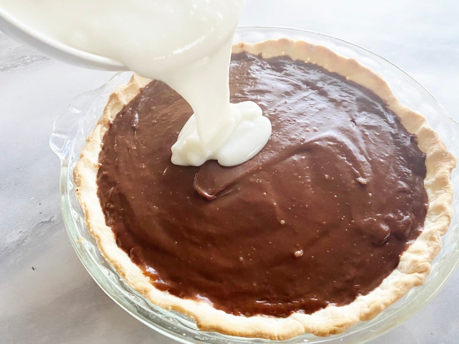 haupia layer being poured onto the chocolate layer