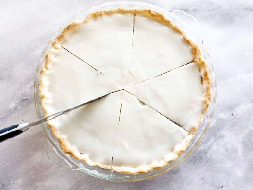 whole haupia pie being cut into slices