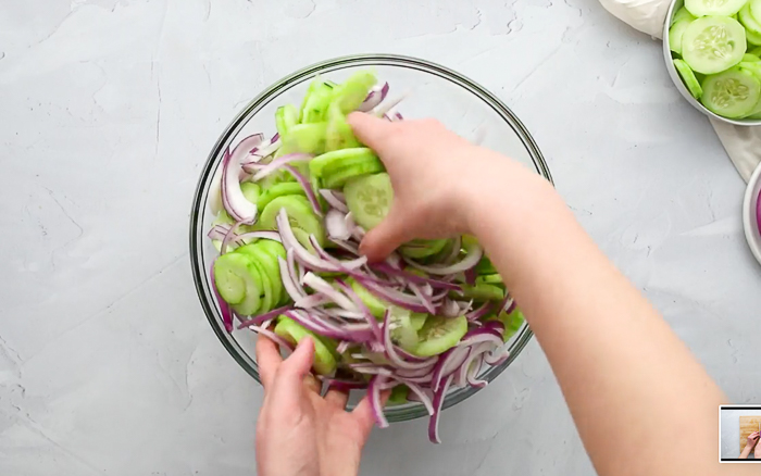 Mixing cucumbers and onions