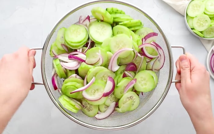 Draining marinade from cucumbers