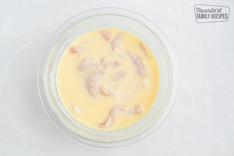 Chicken marinating in buttermilk and egg