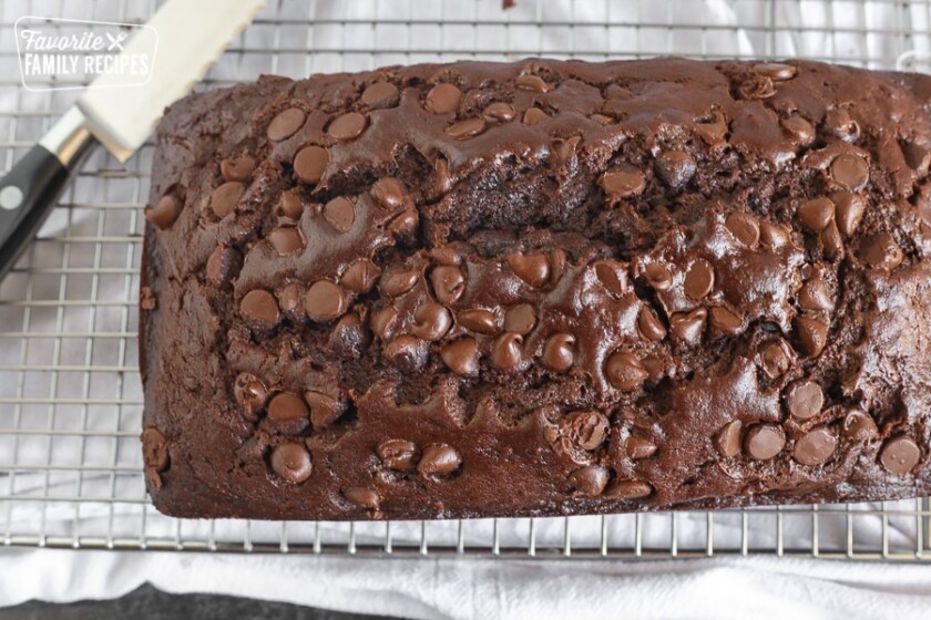 A loaf of baked Chocolate Zucchini Bread with chocolate chips on top.