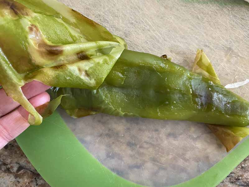 Blistered skin being removed from Hatch chile