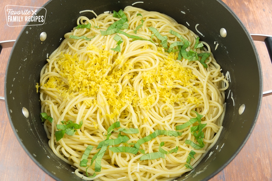 Pasta topped with lemon sauce, basil, and lemon zest.