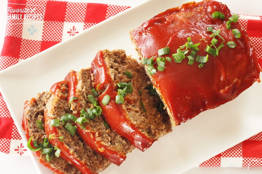 Meatloaf with slices on a plate.