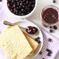 spoonful of huckleberry jam on a plate with bread