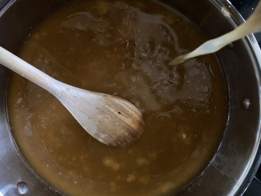broth being stirred in a pot