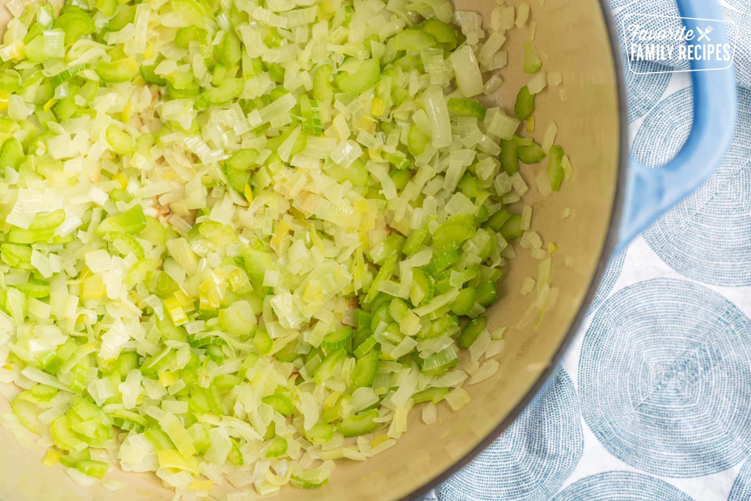 Celery, leeks, and onions cooked in a large pot