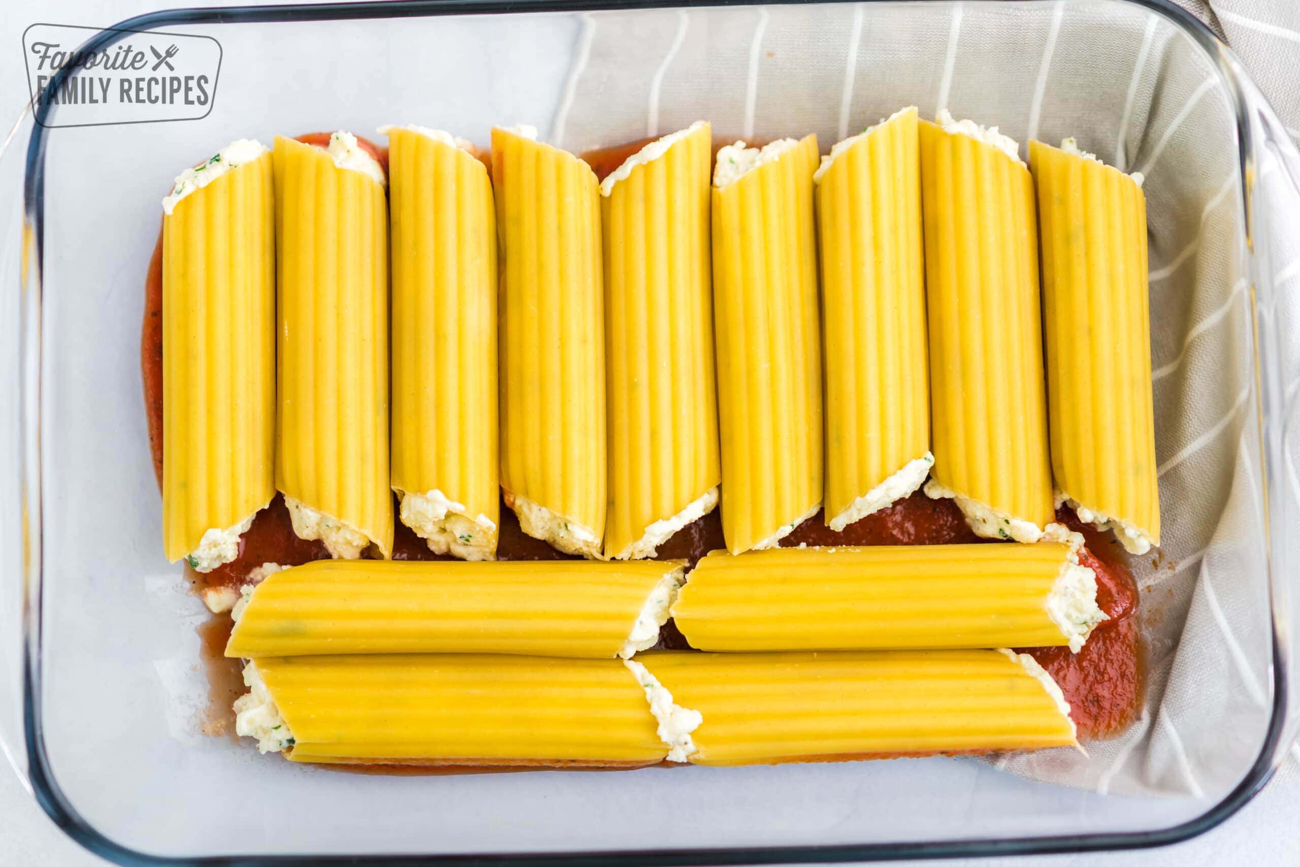 Cheese manicotti in a baking dish.