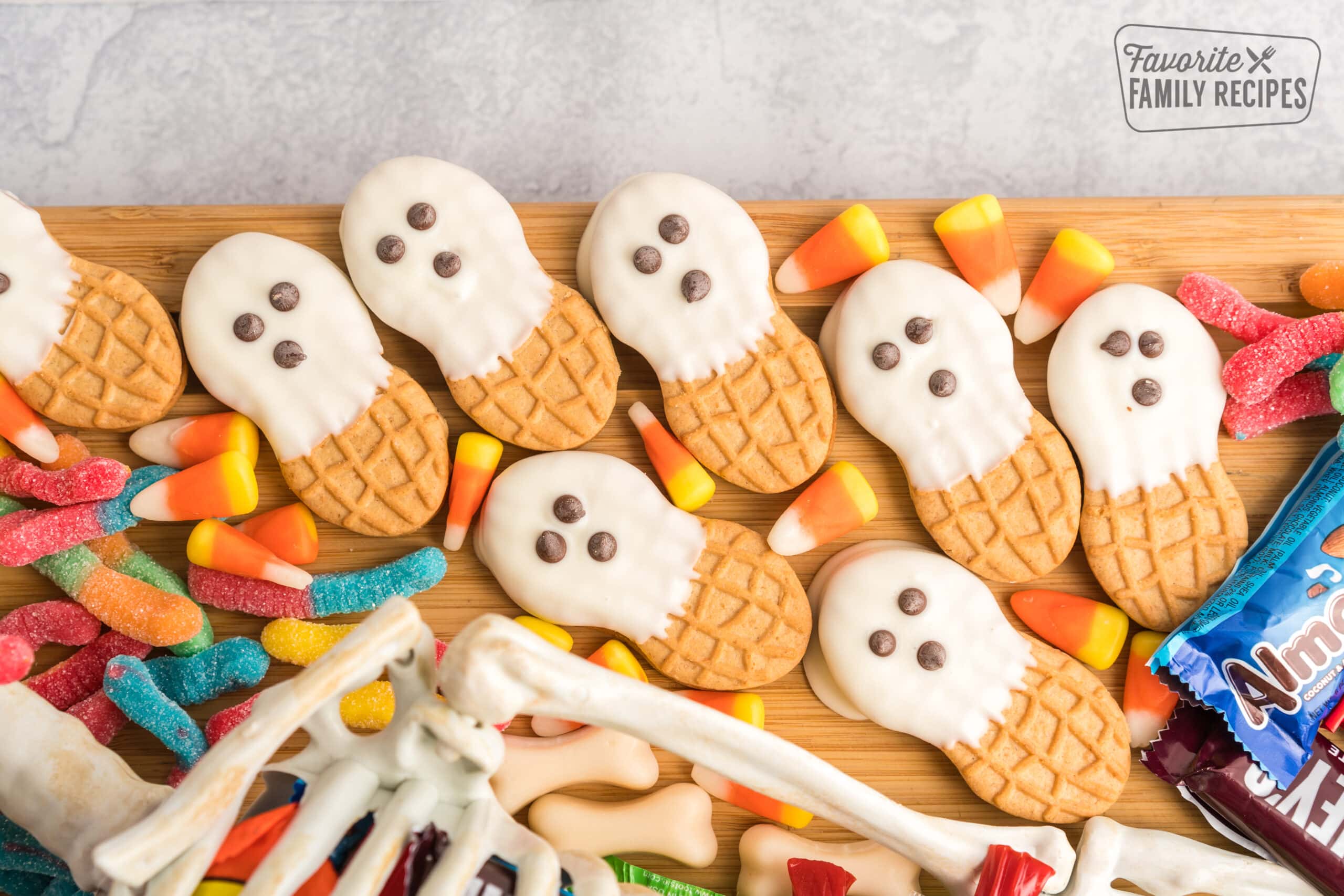 Ghosts made out of Nutter Butters dipped in white chocolate with mini chocolate chip eyes and placed on a Halloween Charcuterie Board. 