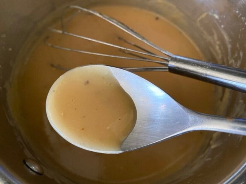 spoon with poutine beef gravy