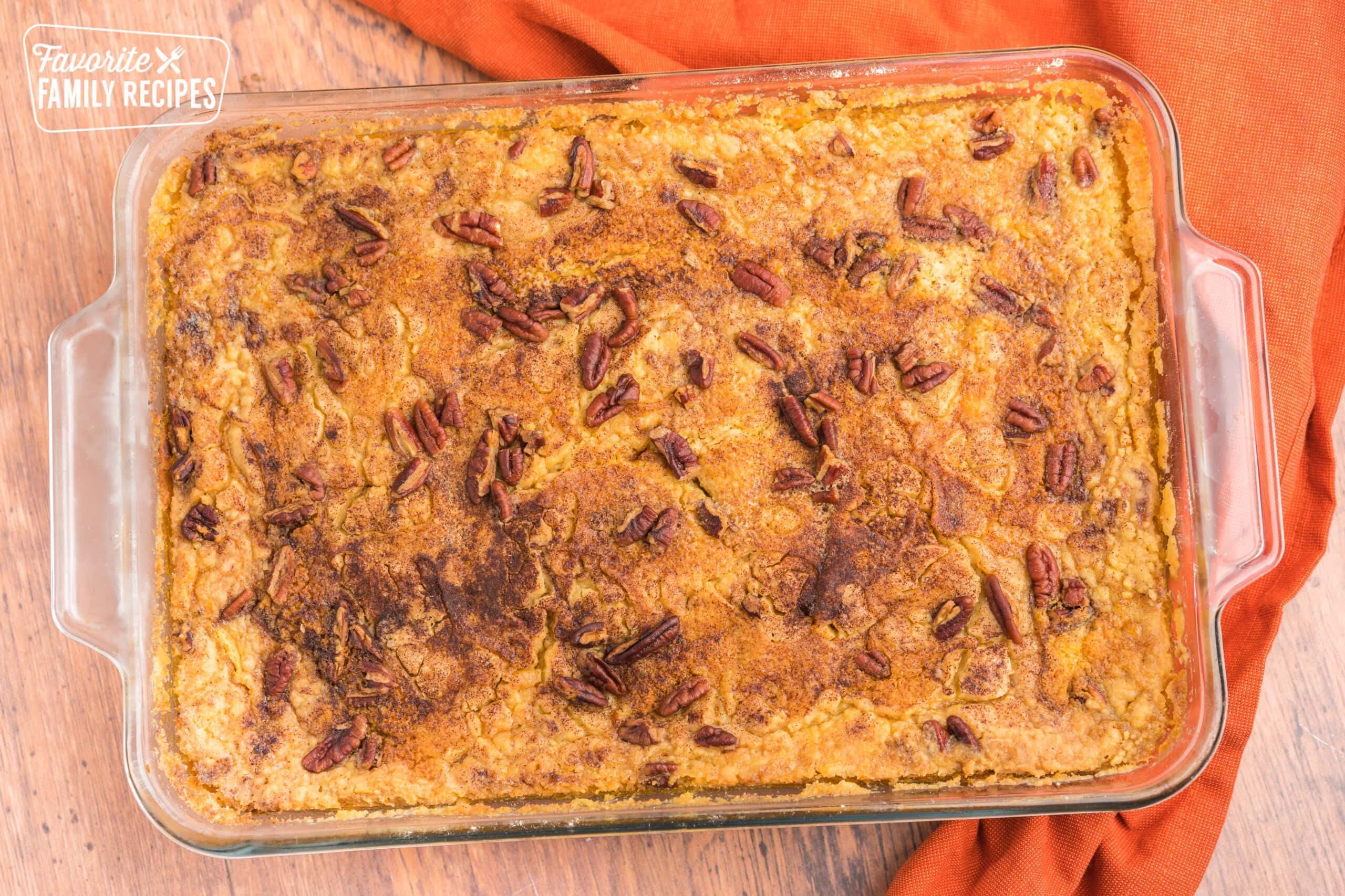 Baked pumpkin cobbler in a glass casserole dish.