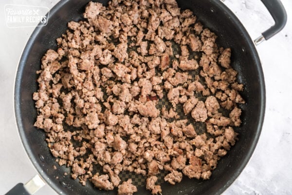 Browned sausage in a skillet to make biscuits and sausage gravy.