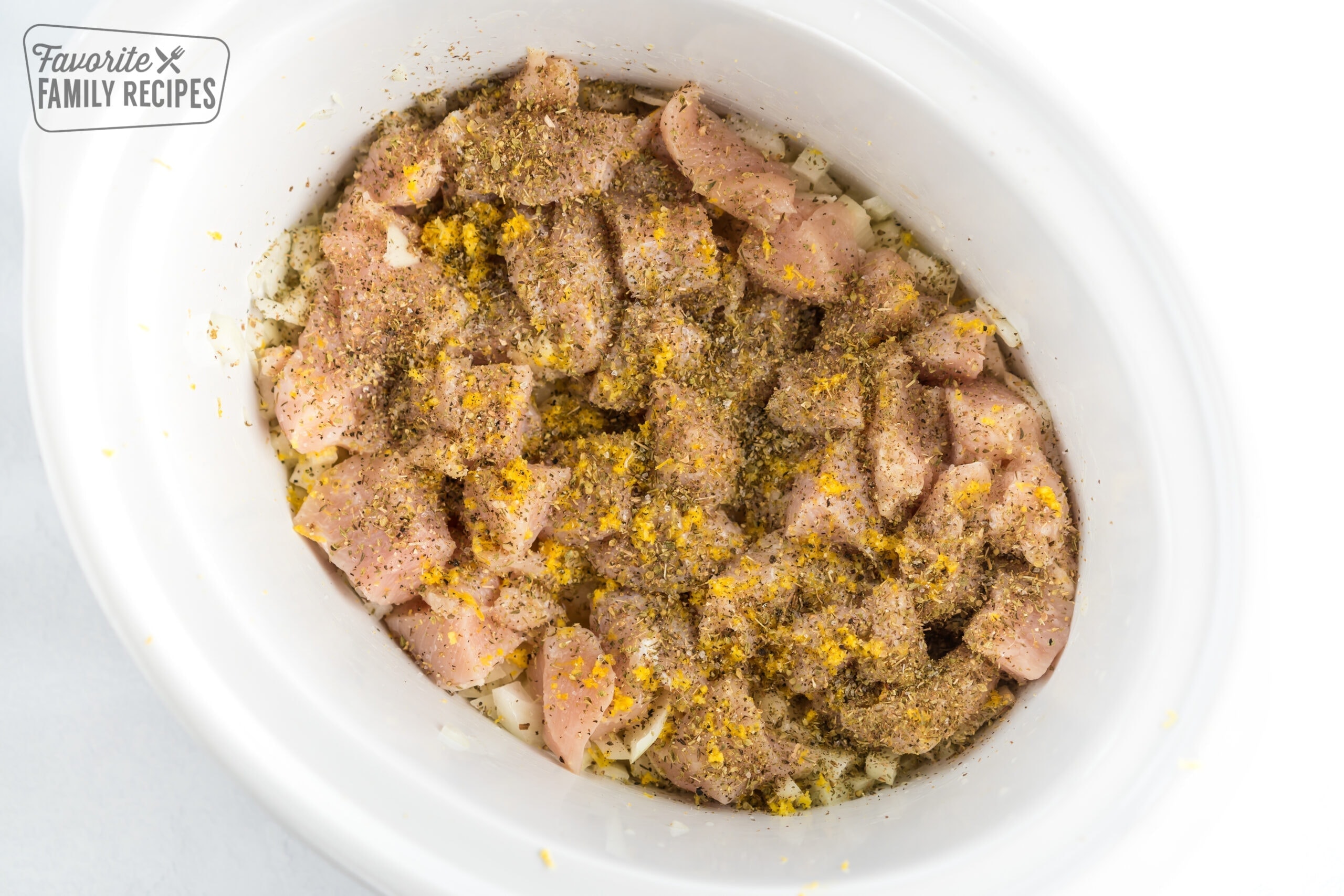 chicken and spices in a crock pot