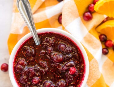 Cranberry Orange sauce with fresh cranberries and oranges on the side
