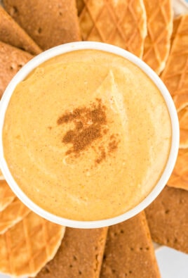 Pumpkin dip in a bowl sprinkled with cinnamon