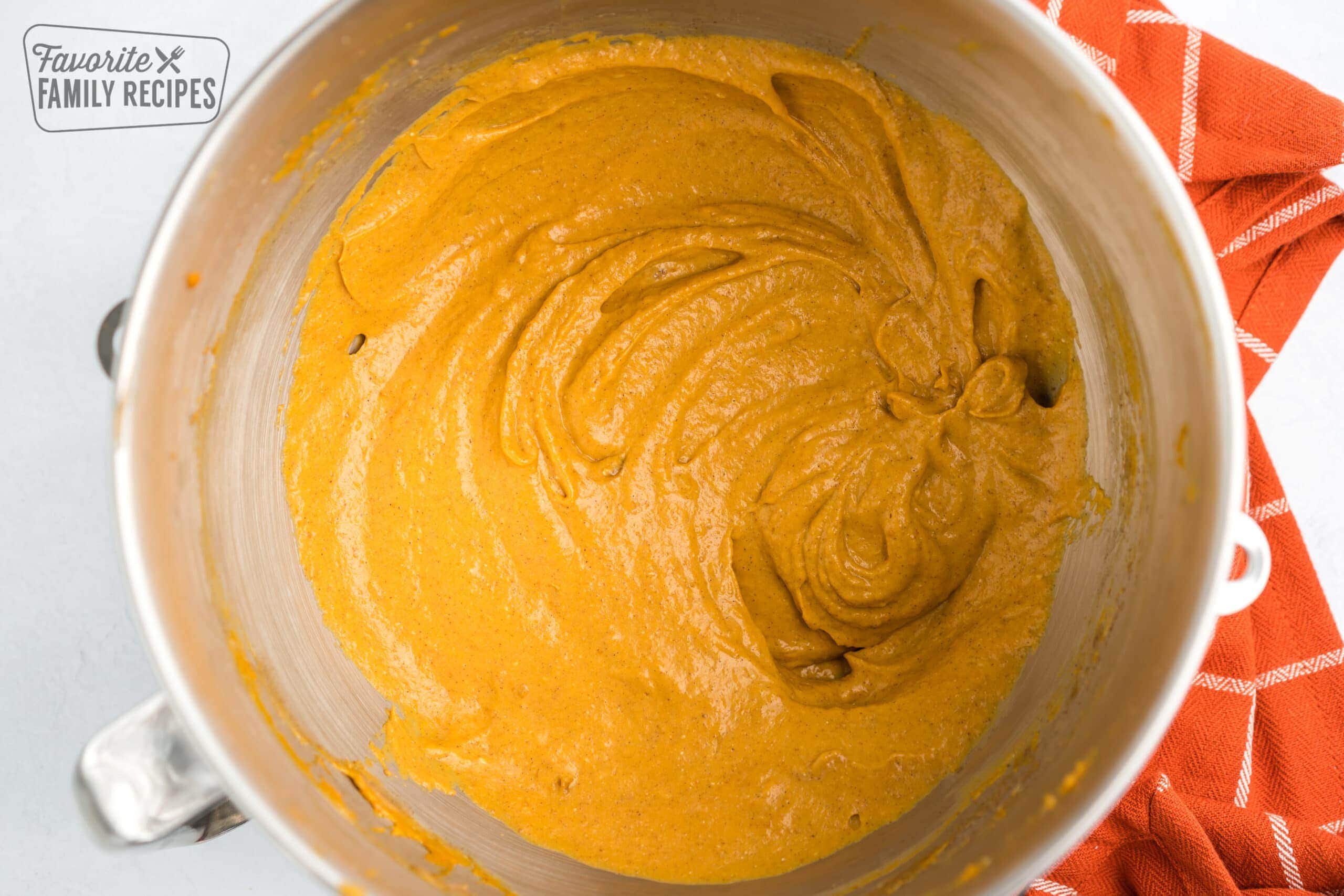 Cream cheese and pumpkin combined in a bowl