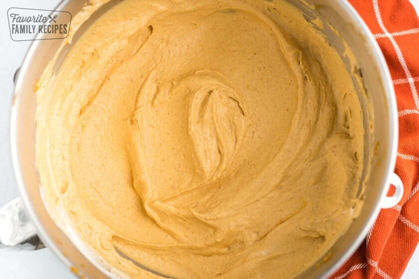Pumpkin mousse filling mixed in a silver mixing bowl