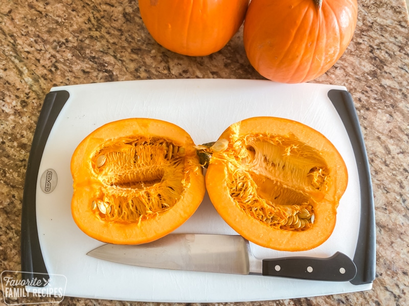 Pumpkin cut in half with seeds and strings