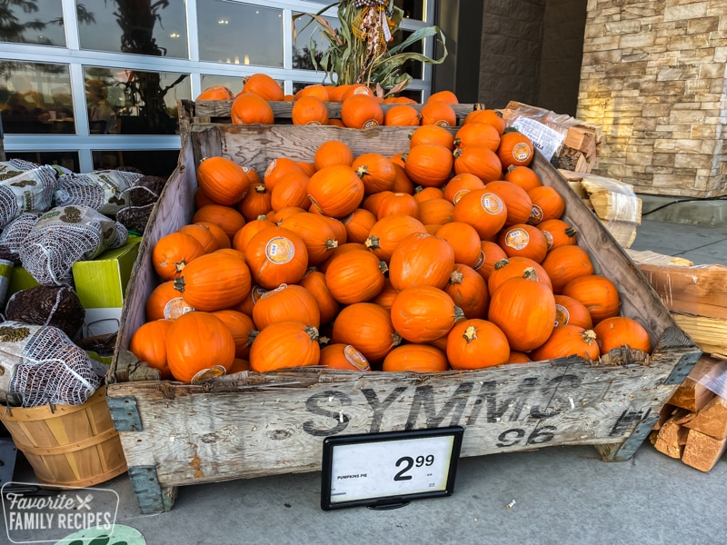 Large wooden crate full of pumpkins.