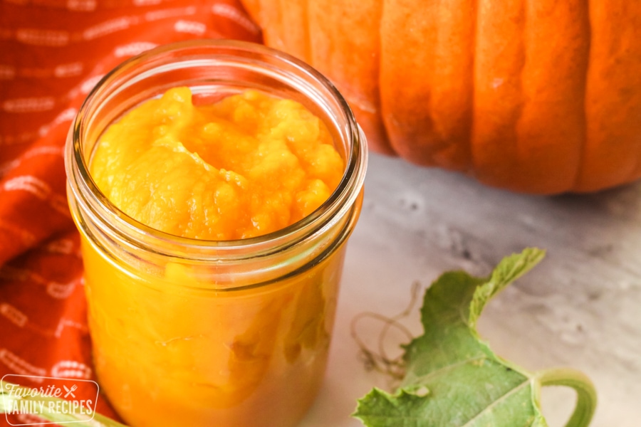 Pumpkin puree in a glass jar.