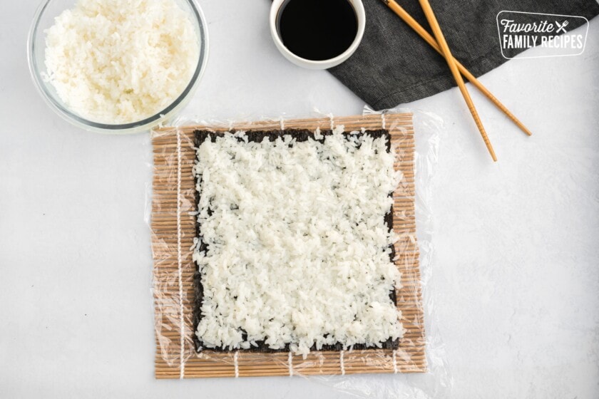 Seaweed and rice on a bamboo sushi mat